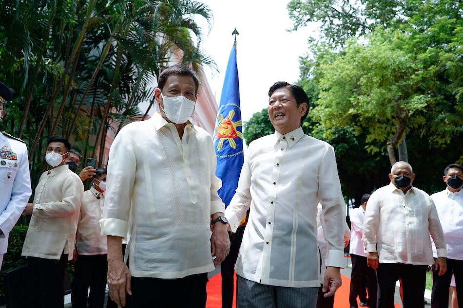 Outgoing President Rodrigo Duterte listens to successor President Ferdinand Marcos, Jr after the departure honors at the Malacanang Palace on June 30, 2022. King Rodriguez, Presidential Photo