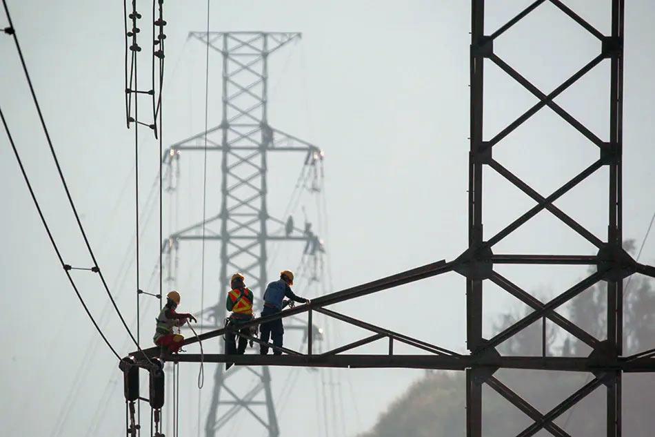 Workers fix a power transmission line near Tagaytay City on January 21, 2020. Jonathan Cellona, ABS-CBN News/file