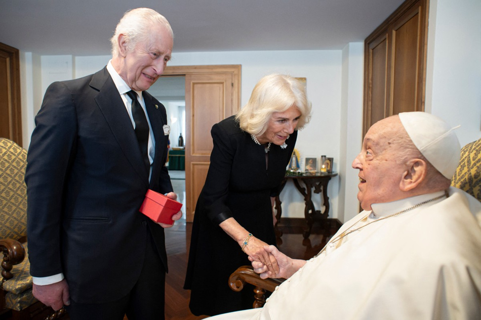This photo taken on April 9, 2025 and handout on April 10, 2025 by The Vatican Media shows Pope Francis during a private meeting with Britain's King Charles III and Queen Camilla in The Vatican. Handout / VATICAN MEDIA / AFP